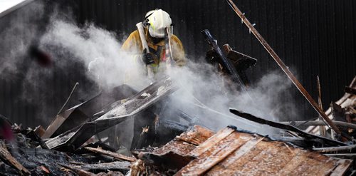 PHIL HOSSACK / WINNIPEG FREE PRESS  - A Letellier firefighter works a hot spot Monday afternoon after an overnight fire destroyed the small community's Hotel and bar. See story.  - February 27, 2017