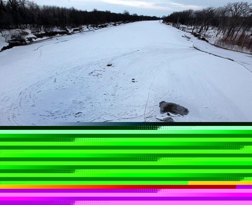 PHIL HOSSACK / WINNIPEG FREE PRESS  - Open water creeping up towards tracks around an old ice fishing spot, the Red River flows under a bridge near Emerson.See story.  - February 27, 2017