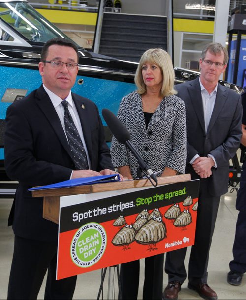 BORIS MINKEVICH / WINNIPEG FREE PRESS
NEWS - From left: Gimili MLA Jeff Wharton,  Sustainable Development Minister Cathy Cox, and Geoff Powell from Mid-Canada Marine and Powersports Dealers Association pose with some examples of Zebra Muscles at MB Gov. press conference launching a public awareness campaign called "Spot the Stripes and Stop the Spread". Photo taken at Enns Brothers, 925 Lagimodiere Blvd. March 2, 2017 170302