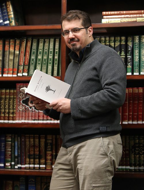 JASON HALSTEAD / WINNIPEG FREE PRESS

Teacher Idris Elbakri holds the book Being Muslim: A Practical Guide, by Asad Tarsin, in the library of the Winnipeg Grand Mosque on Waverley Street on March 2, 2017. Elbakri uses the book as he teaches the Manitoba Islamic Societys 12-week course on Being Muslim. The course is open to both Muslims and non-Muslims.
RE: Suderman Faith column