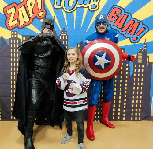 BORIS MINKEVICH / WINNIPEG FREE PRESS
STANDUP -  Robert H Smith School's Community Breakfast. All Proceeds Go to The True North Youth Foundation's Project 11 Mental Health Awareness for Kids. Grade 3 student Maggie McMillan poses with some superheros at a booth set up for the kids during the event. March 3, 2017 170303