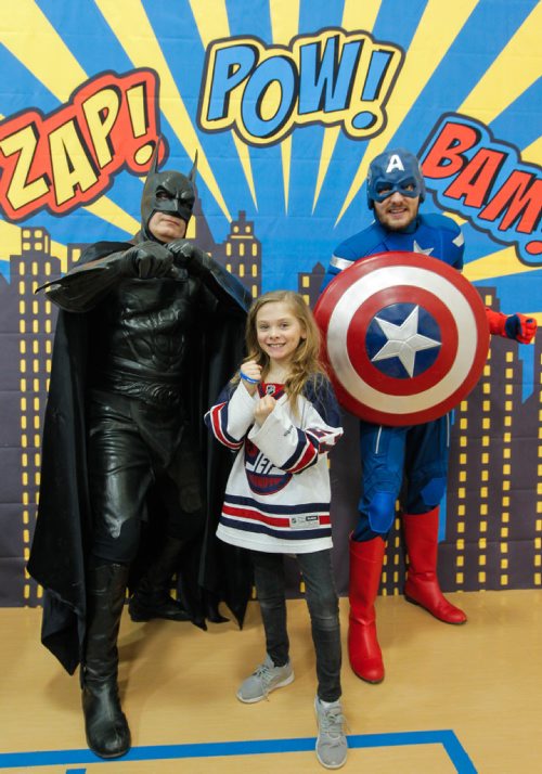 BORIS MINKEVICH / WINNIPEG FREE PRESS
STANDUP -  Robert H Smith School's Community Breakfast. All Proceeds Go to The True North Youth Foundation's Project 11 Mental Health Awareness for Kids. Grade 3 student Maggie McMillan poses with some superheros at a booth set up for the kids during the event. March 3, 2017 170303