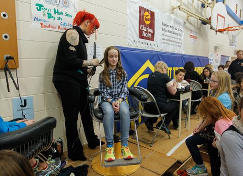 BORIS MINKEVICH / WINNIPEG FREE PRESS
STANDUP -  Robert H Smith School's Community Breakfast. All Proceeds Go to The True North Youth Foundation's Project 11 Mental Health Awareness for Kids. Hair stylist Morgan Paul from Jerry's Hair Salon & Day Spa puts some curls into grade 6 student Madeline Garcia. Local businesses participated in the event. March 3, 2017 170303