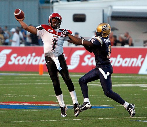 BORIS MINKEVICH / WINNIPEG FREE PRESS  080924 Calgary's #1 Henry Burris gets attacked by #0 Ike Charlton in the second half.