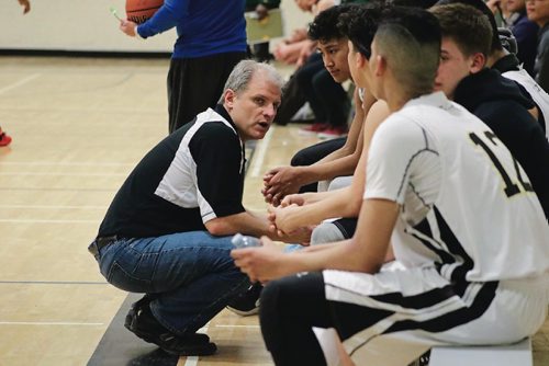 Canstar Community News Phil Penner, Garden City Collegiate basketball coach, speaks to the junior varsity team during a game o Feb. 28, 2017.