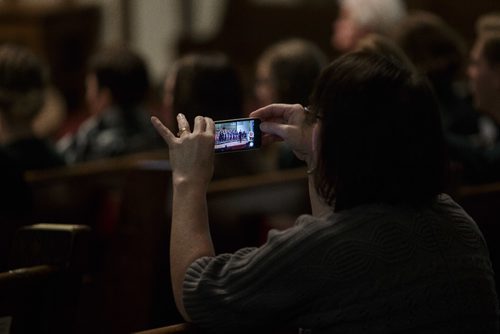 MIKE DEAL / WINNIPEG FREE PRESS
A person in the pews records a video on their phone while the West Kildonan Collegiate Choir performs in the Westminster United Church Monday afternoon during the 99th annual Winnipeg Music Festival which goes until March 19th.
170306 - Monday, March 06, 2017.