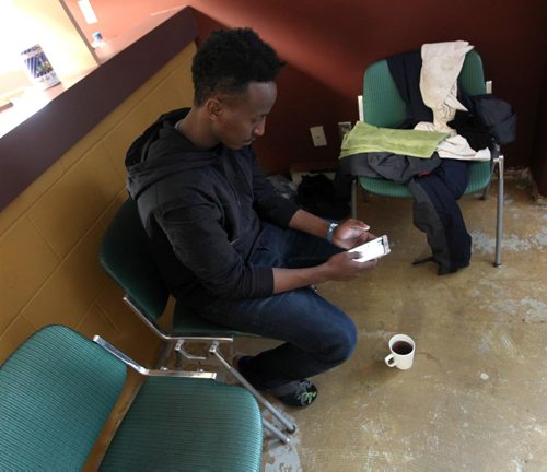 PHIL HOSSACK / WINNIPEG FREE PRESS  - Hurry up and wait - Ismail Mohamed spends time with his smart phone at the Salvation Army Shelter between filling out refugee claims. Ismail is from Somalia and recently walked across the border at Emerson. Melissa Martin story.  -  March 3, 2017