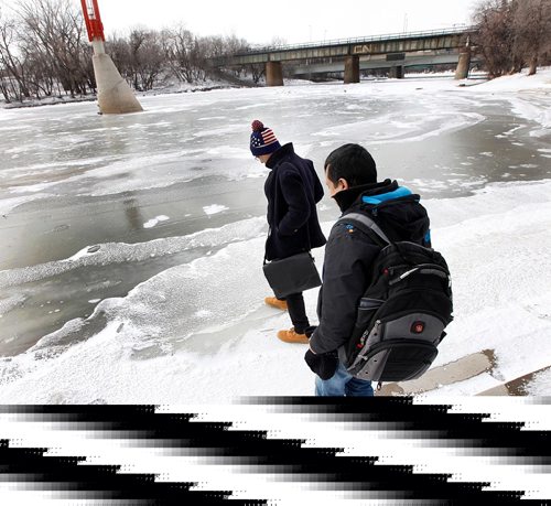 49.8 FEATURE :  
PHIL HOSSACK / WINNIPEG FREE PRESS  - Shahadat Hossain (left) and Subir Barman take their first tenative steps to walk on a frozen Assinaboine river Wednesday morning, neither had ever seen a frozen waterway.  Randy Turner / Melissa Martin story.  -  March 3, 2017