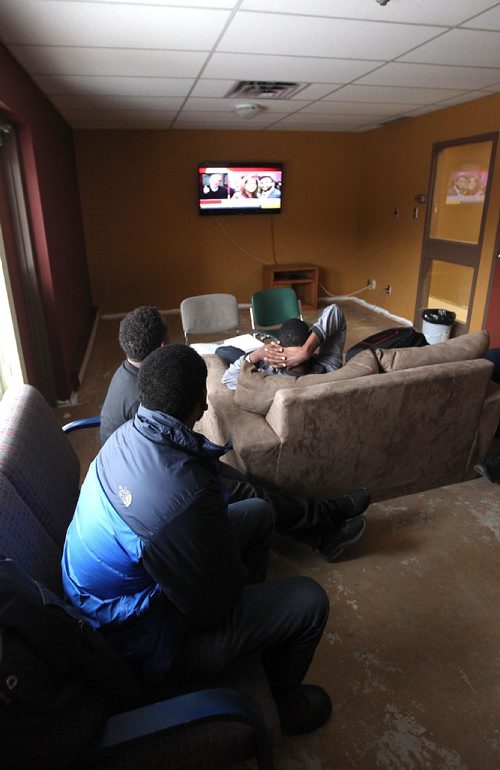 49.8 FEATURE :  
PHIL HOSSACK / WINNIPEG FREE PRESS  - Hurry up and wait - After risking  everything and finally seeking safety by walki g across the US border at Emerson into Canada, Asylum seekers watch the news in a  common room at the Salvation Army Shelter.  Melissa Martin story.  -  March 3, 2017