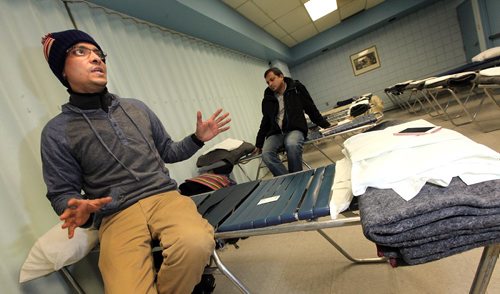 49.8 FEATURE :  
PHIL HOSSACK / WINNIPEG FREE PRESS  - Hurry up and wait -  Shahadat Hossain (left) and  Subir Barmanspend time waiting at their Salvation Army overflow sleeping quarters. This area is normally part of a dining room.Melissa Martin story.  -  March 3, 2017