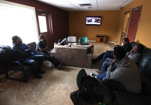 49.8 FEATURE :  
PHIL HOSSACK / WINNIPEG FREE PRESS  - Hurry up and wait - After risking  everything and finally seeking safety by walki g across the US border at Emerson into Canada, Asylum seekers watch the news in a  common room at the Salvation Army Shelter.  Melissa Martin story.  -  March 3, 2017