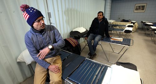 49.8 FEATURE :  
PHIL HOSSACK / WINNIPEG FREE PRESS  - Hurry up and wait -  Shahadat Hossain (left) and  Subir Barmanspend time waiting at their Salvation Army overflow sleeping quarters. This area is normally part of a dining room.Melissa Martin story.  -  March 3, 2017