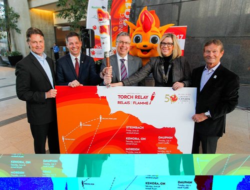 BORIS MINKEVICH / WINNIPEG FREE PRESS
LOCAL - 2017 Canada Summer Games Roly McLenahan Torch will make its way across the province during the Manitoba Hydro Torch Relay. The torch will be lit June 6 at the Centennial Flame on Parliament Hill in Ottawa and will arrive in Winnipeg on July 26. Today they announced the torch run route and application process at MB Hydro headquarters on Portage Avenue. From left: President and CEO, 2017 Canada Games Host Society Jeff Hnatiuk, Winnipeg Mayor Brian Bowman, President & CEO of Manitoba Hydro Kelvin Shepherd, the 2017 Canada Summer Games' mascot Niibin, Minister of Sport, Culture and Heritage Rochelle Squire, and 2017 Canada Summer Games Host Society co-chair Hubert Mesman pose for a photo with the map and torch. Alexandra Paul story. March 9, 2017 170309