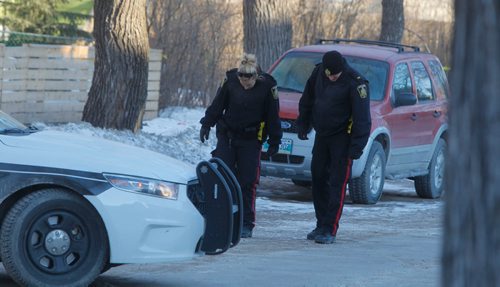 BORIS MINKEVICH / WINNIPEG FREE PRESS
Police and Forensic Unit members at the crime scene in the 200 block of Spence Street this morning. March 13, 2017 170313