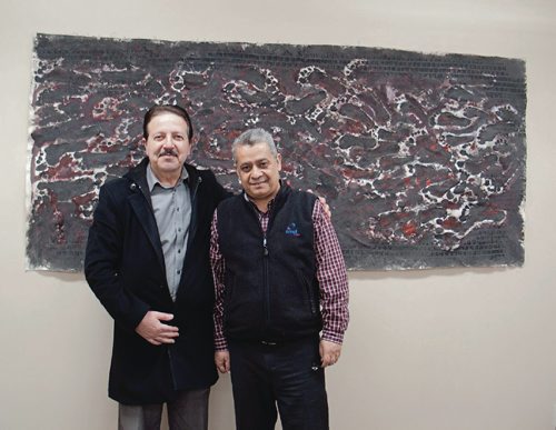 Canstar Community News Auday Ab Redah, an Arabic speaking settlement worker, and Nadim Ado, a Syrian refugee and artist who has found a home in Elmwood, at a showing of Ado's work at the Elmwood Community Resource Centre. (SHELDON BIRNIE/CANSTAR/THE HERALD)
