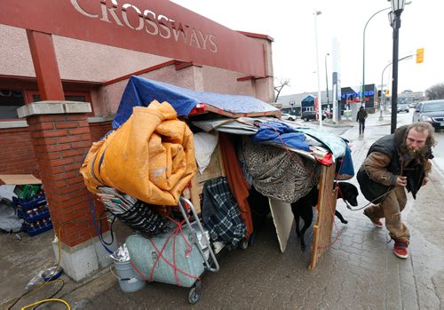 WAYNE GLOWACKI / WINNIPEG FREE PRESS

John tries to coax his dog Ammo to stay out of the rain as he packs up his belongings Thursday after being forced out of a location outside the Crossways in Common, Hope Mennonite neighbourhood church along Broadway. Alex Paul story  March 16    2017