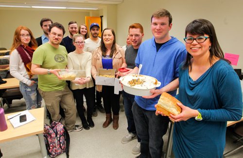 BORIS MINKEVICH / WINNIPEG FREE PRESS
Food front - University of Manitoba prof Sarah Elvins teaches her history of food class in University College. Her students did some cooking demonstrations from old recipe books and shared their findings in there class. Professor Elvins, right holding a half loaf of bread, poses for a photo with her class and all the food that they cooked from super old cookbooks. ALISON GILLMOR STORY. March 16, 2017 170316