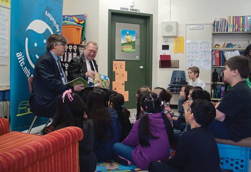 Canstar Community News March 16, 2017 - (From left) Ian Wishart, provincial minister of education, and Ralph Eichler, provincial agriculture minister, read "What's Growing Around Us?" to a Grade 3 class at Sherwood School (509 Grey St.) during an Agriculture in the Classroom - Manitoba presentation. (SHELDON BIRNIE/CANSTAR/THE HERALD)