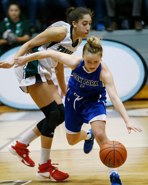 JOHN WOODS / WINNIPEG FREE PRESS
 Oak Park Raiders' Lauren Bartlett (1) breaks away from Vincent Massey Trojans' Niyah Becker (14) in the Manitoba High School 2017 Varsity Girls Basketball Championship at the University of Manitoba Monday, March 20, 2017.