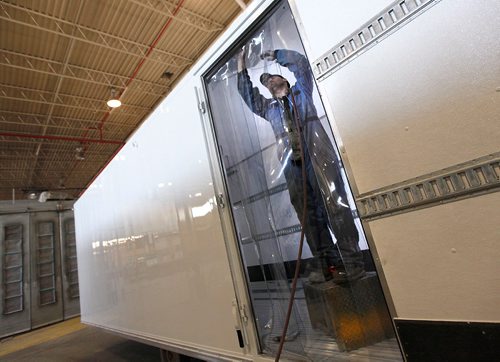 PHIL HOSSACK / WINNIPEG FREE PRESS  -  International Truck Body worker Adam Chateauneuf-Pelland installs a plastic sheeting inner door on a custom refiridgerated unit to be installed on a truck frame in the Curch ave production centre.  See Murray McNeill's story. -  March 21, 2017