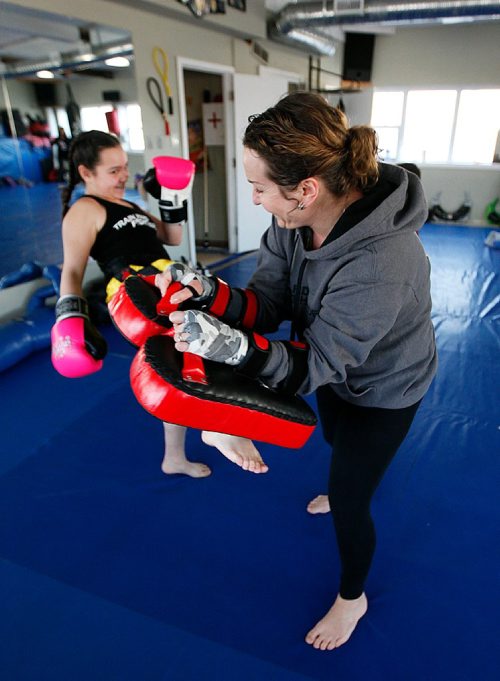 PHIL HOSSACK / WINNIPEG FREE PRESS  -  Jenelle Vincent-Oasis hold the pads while her daughter Jada, 11 delivers a series of punches and kicks as they warm up for their regular kick boxing class Tuesday. See Steve Lyons story. -  March 21, 2017