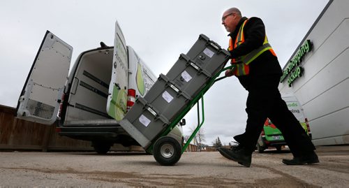 WAYNE GLOWACKI / WINNIPEG FREE PRESS

Personal Delivery Assistant John McLennan with crates that hold online grocery orders by the delivery vans at  the Save On Foods in the Northgate shopping centre on McPhillips St. 
Murray McNeill  story    March 24    2017