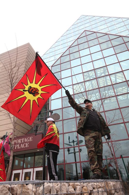 RUTH BONNEVILLE  / WINNIPEG FREE PRESS

Vern DeLaronde, part of an activist group called the Urban Warrior Alliance, holds flags in area with others in the group in back of Portage Place Shopping Centre Saturday, a known drug-dealing site, to stand up against dealers in the area that are making it unsafe for people, 
See Bill Redekop story. 

March 25, 2017
