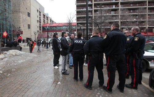 RUTH BONNEVILLE  / WINNIPEG FREE PRESS

Members of an activist group called the Urban Warrior Alliance talk to police officers in back of Portage Place Shopping Centre Saturday, a known drug-dealing site, to express their concern with dealers in the area that are making it unsafe for people, 
See Bill Redekop story. 

March 25, 2017