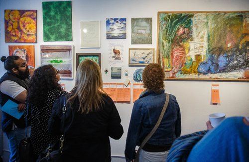 MIKE DEAL / WINNIPEG FREE PRESS
A packed house of art lovers mingle during MAWAs annual Over the Top art auction and cupcake party at their location on Main Street Sunday afternoon.
170326 - Sunday, March 26, 2017.