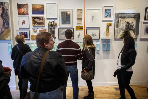 MIKE DEAL / WINNIPEG FREE PRESS
A packed house of art lovers mingle during MAWAs annual Over the Top art auction and cupcake party at their location on Main Street Sunday afternoon.
170326 - Sunday, March 26, 2017.