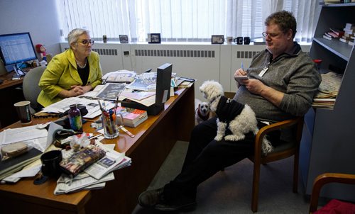 MIKE DEAL / WINNIPEG FREE PRESS
Doug Spiers and Shannon Sampert talk about their dogs for Doug's column while Shannon's dog Norman sits on Doug's lap. The Free Press is starting an experiment, allowing employees to bring their dog into work. 
170320 - Monday, March 20, 2017.