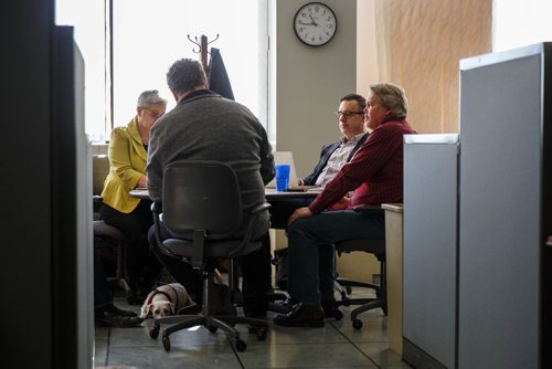 MIKE DEAL / WINNIPEG FREE PRESS
Bogey sits under the table while Winnipeg Free Press staff Doug Spiers, Shannon Sampert, Dan Lett and Carl DeGures conduct a meeting in the newsroom. The Free Press is starting an experiment, allowing employees to bring their dog into work. 
170320 - Monday, March 20, 2017.