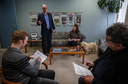 MIKE DEAL / WINNIPEG FREE PRESS
Winnipeg Free Press Editor Paul Samyn with designer Leesa Dahl, City Editor Shane Minkin and Night editor Chad Scarsbrook during a handover meeting with Leesa's dog Oliver. The Free Press is starting an experiment, allowing employees to bring their dog into work. 
170322 - Wednesday, March 22, 2017.