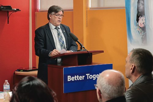 Canstar Community News Minister of Education Ian Wishart speaks to a crowd of newcomers and journalists at Welcome Place on Feb. 23, 2017.