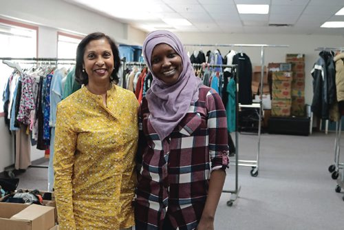 Canstar Community News Canadian Muslim Womens Institute president Yasmin Ali and staff member Emita Mahmat in front of the racks of clothing they received in a week on Feb. 26, 2017.