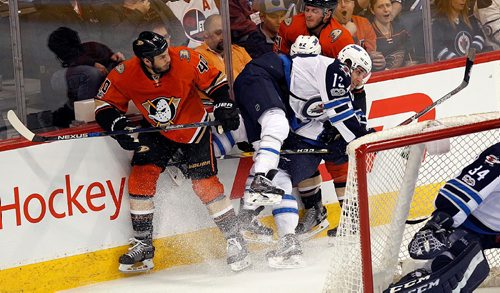 PHIL HOSSACK /WINNIPEG FREE PRESS - Anaheim Duck #40 Jared Boll upends Winnipeg Jet # 13 Brandon Tanev into Jet #62 Nelson Nogier and Duck#21 Chris Wagner at the MTS Centre Thursday.   March 30, 2017
