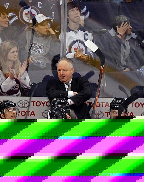 PHIL HOSSACK /WINNIPEG FREE PRESS - Anaheim Duck's coach Randy Carlyle checks the scoreboard as the Duck's notch their third goal against the Jets early in the second period Thursday, see story.  March 30, 2017