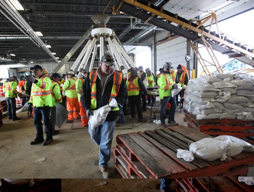 RUTH BONNEVILLE  / WINNIPEG FREE PRESS

City of Winnipeg workers fill and stack sandbags to be delivered to homes along the river at their east Yards Complex off Nairn Thursday.  
 
March 31, 2017