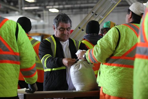 RUTH BONNEVILLE  / WINNIPEG FREE PRESS

City of Winnipeg workers fill and stack sandbags to be delivered to homes along the river at their east Yards Complex off Nairn Thursday.  
 
March 31, 2017