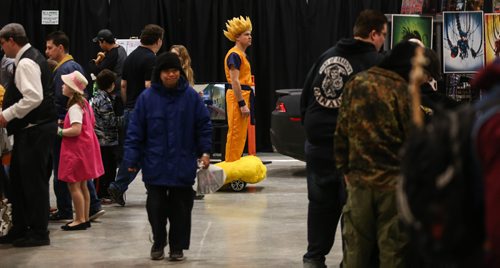 MIKE DEAL / WINNIPEG FREE PRESS
Sean Palmer rolls along dressed as Goku from the Dragon Ball Z anime during the Manitoba Comic Con at the convention centre Sunday afternoon.
170402 - Sunday, April 02, 2017.