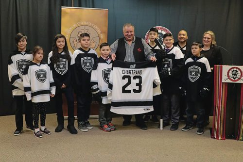 Canstar Community News David Chartrand (middle), president of the Manitoba Metis Federation, received a costumed Norquay Knights jersey on Mar. 23, 2017.