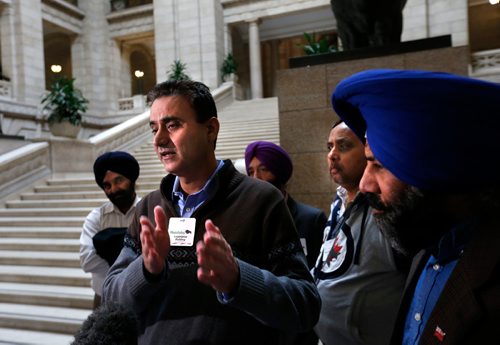 WAYNE GLOWACKI / WINNIPEG FREE PRESS

In centre, Randy Chhokar with fellow cab drivers after question period in the Manitoba Legislature Monday. Nick Martin/Larry Kusch  stories  April 3     2017