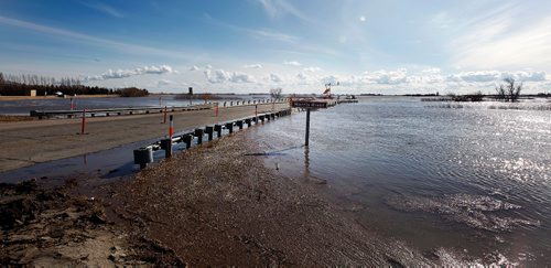 PHIL HOSSACK / WINNIPEG FREE PRESS  - High water along #3 Highway near Brunkhild has traffic limited to one lane on the busy highway behind a temporary dike.  -  April 3, 2017