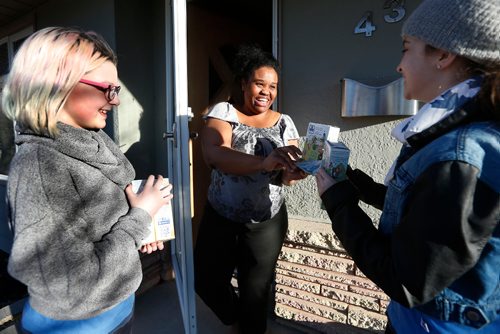 JOHN WOODS / WINNIPEG FREE PRESS
Tanecia Beech-Gilpin buys cookies from guides Katrina McKnight and Angelina Morris as they sell cookies door to door in Windsor Park Monday, April 3, 2017. 2017 is the 90th anniversary of Guides Canada