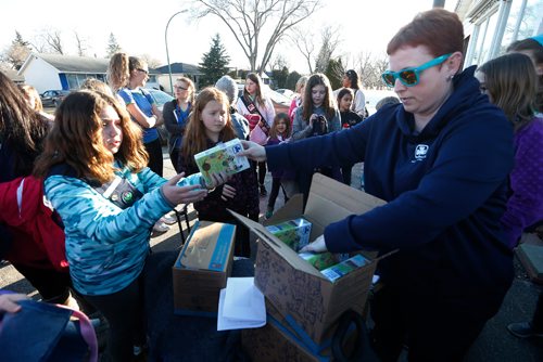 JOHN WOODS / WINNIPEG FREE PRESS
Tamara Elias, leader of the 201st, hands out cookies to guides before they head out to sell cookies door to door in Windsor Park Monday, April 3, 2017. 2017 is the 90th anniversary of Guides Canada