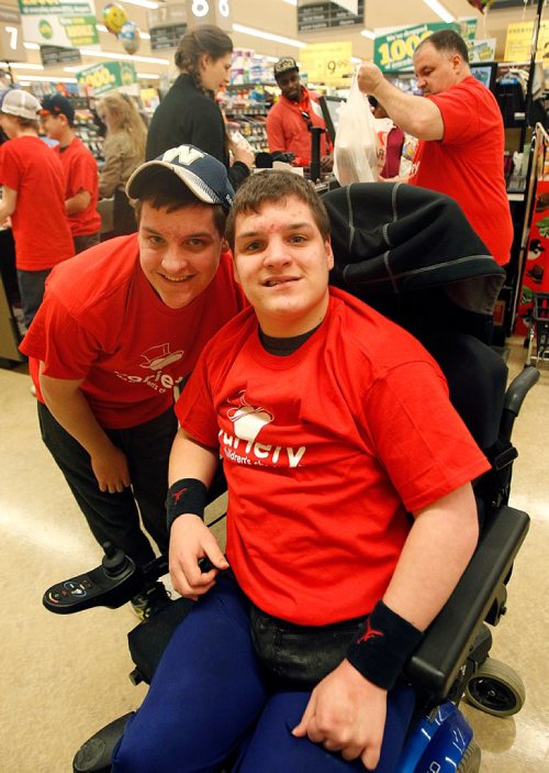 PHIL HOSSACK / WINNIPEG FREE PRESS  -  Jeremy and Jordon Rogodzinski  pose at the River and Osborne Safeway tuesday taking part in the celebrity bagging event for the Variety's Gold Heart Campaign. See Doug Spiers story -  April 4, 2017