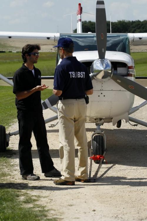 WINNIPEG, MAN: AUGUST 8, 2008 -- The pilot (left) of the small plane that made an emergency landing on Highway 8, just north of St. Andrew's Airport, explains the situation to Peter Hildebrand of the Transportation Safety Board of Canada near Winnipeg, Man. August 8, 2008..  SARAH KEARNEY/WINNIPEG FREE PRESS