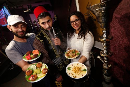 JOHN WOODS / WINNIPEG FREE PRESS
Mohammad Naser (L) and Heba Abd El Hamid (R), owners of Arabesque Hookah Cafe and Restaurant, photographed with Mohammed Huri (C) smoking a hookah in Winnipeg Sunday, April 9, 2017. Naser, a Syrian refugee who came to Canada in 2012, has hired other refugees to work in the restaurant.