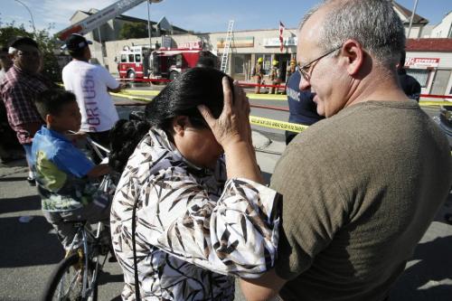 John Woods / Winnipeg Free Press / August 9, 2008 - 080809  - As Winnipeg firefighters tackle the fire a  distraught Glenda Lagadi, owner of the building at 593 - 597 Notre Dame, reacts as her tenant Tony Pereira tells her what he saw as the building caught fire this afternoon Saturday, August 9, 2008.