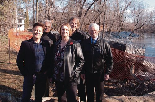 Canstar Community News April 4, 2017 - (From left) St. Paul MLA Ron Schuler, Orest Horechko, East St. Paul mayor Shelley Hart, Charles Posthumus, and Brian Duval stand before a new permanent dike on Bottomley Creek. Schuler was on hand to announce $966,000 in provincial funding for the project. The first phase was completed on March 31, and the second phase is expected to be complete in the fall of 2017. (SHELDON BIRNIE/CANSTAR/THE HERALD)